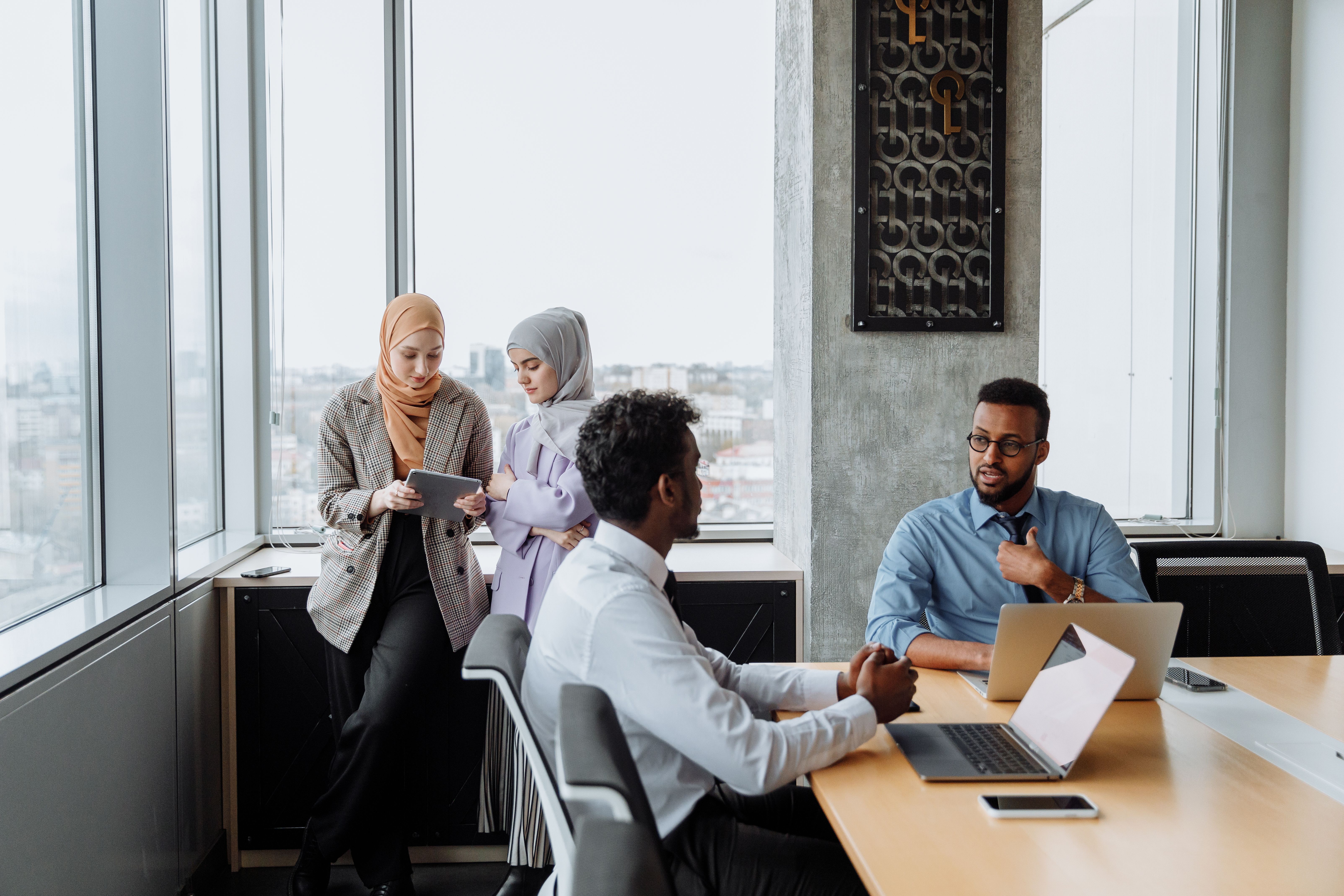 Diverse professionals collaborating around a table in a modern office.