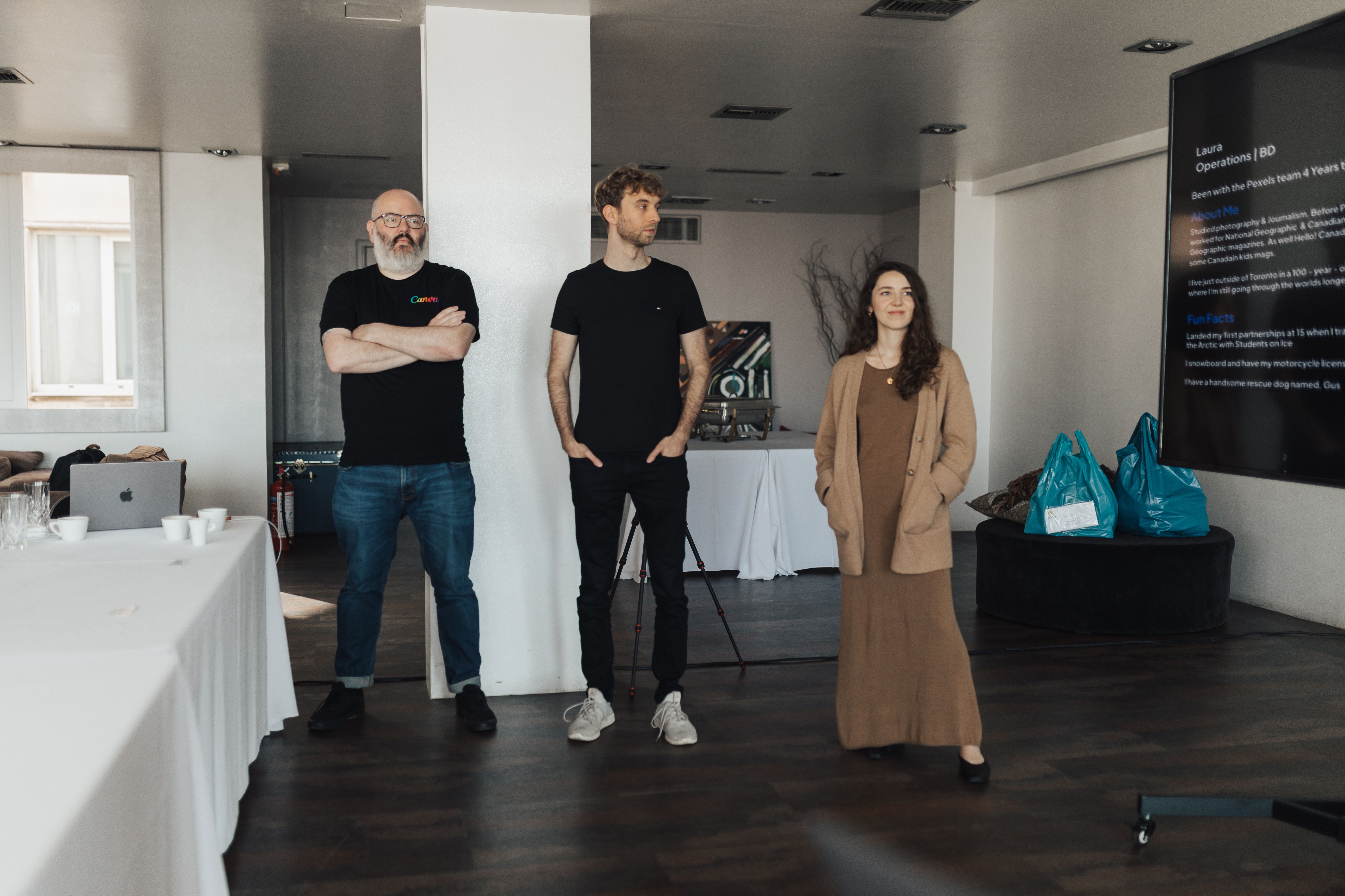 Three professionals presenting ideas in a modern office, showing how strong hiring supports organisational performance.
